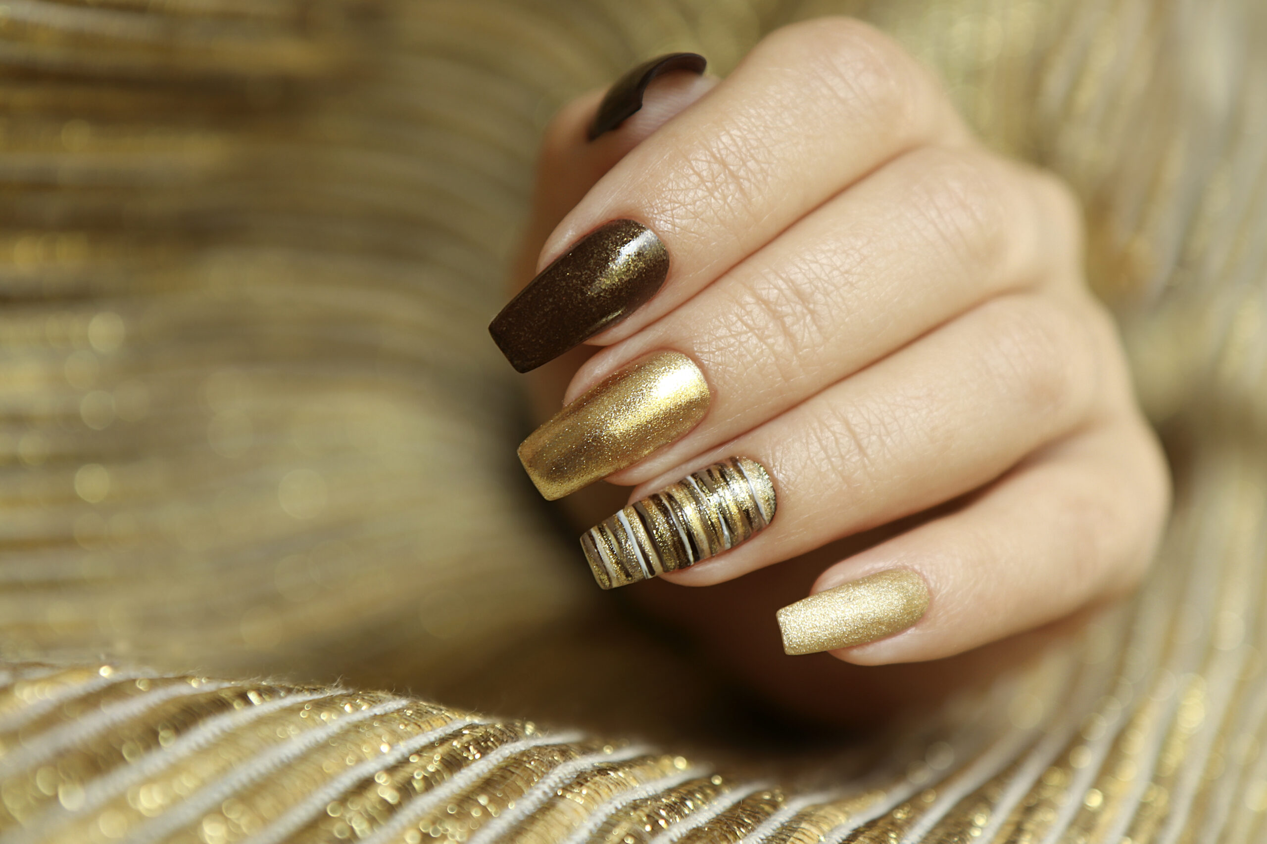 fashionable_manicure_with_matte_golden_color_nail_polish_brown_long